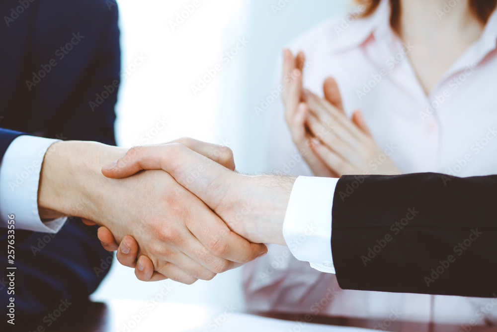 Business people shaking hands finishing up a meeting. Handshake at successful negotiation Business people shaking hands finishing up a meeting. Handshake at successful negotiation