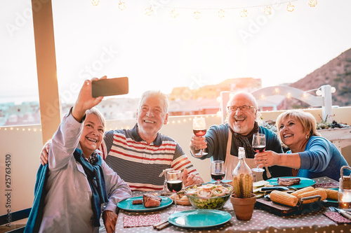 Photography Happy seniors friends taking selfie with mobile smartphone camera at barbecue di