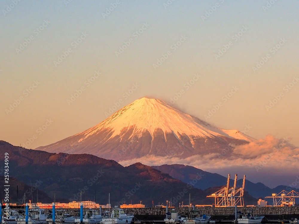 Mt. Fuji on Dream Ferry Mini Cruise traveling from Hamanako Lake, Shizuoka, Japan with sunset sky and industry plant background.