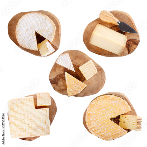 Set of soft French cheese on a cutting boards, isolated on white, top view. Camembert, Livarote, Pont-L'eveque and  pressed cheese from Normandy. photo