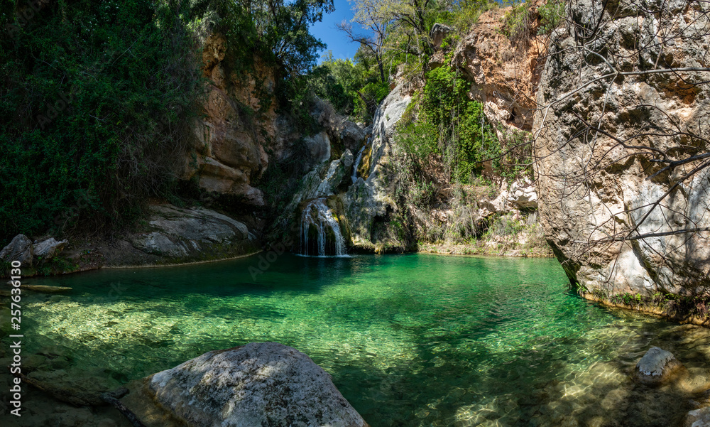 Eagle nest lake in Tarragona with waterfall and green pond Eagle nest lake in Tarragona with waterfall and green pond