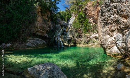 Eagle nest lake in Tarragona with waterfall and green pond