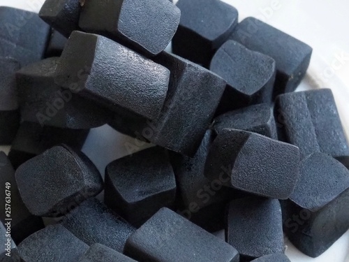 A pile of liquorice sweets close up. Macro photography.