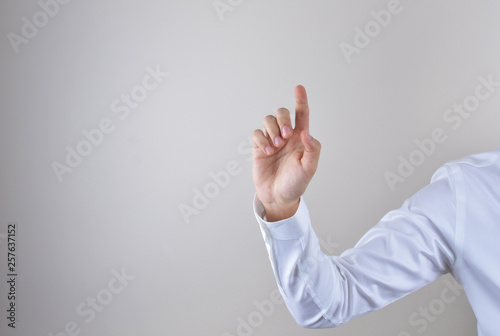 Businessman touching imaginery screen photo