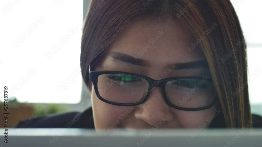 Young woman working computer long hours.Attractive young businesswoman working via computer at office with, closeup girl browsing the internet, looking at monitor of modern Young woman working computer long hours.Attractive young businesswoman working via computer at office with, closeup girl browsing the internet, looking at monitor of modern