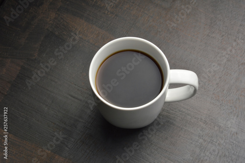 Cup of coffee on black wood table