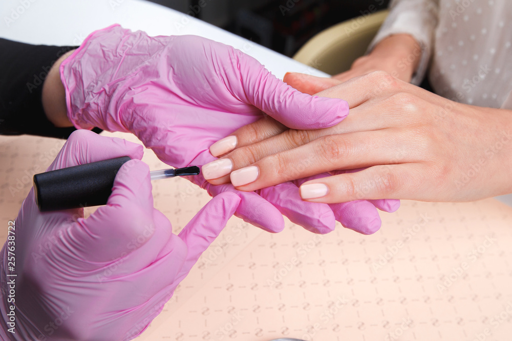 professional manicurist showing colorful nail polish to check the finish result. Nail technician presenting color palette of nail services in beauty salon store. beauty and fashion concept.0 professional manicurist showing colorful nail polish to check the finish result. Nail technician presenting color palette of nail services in beauty salon store. beauty and fashion concept.0