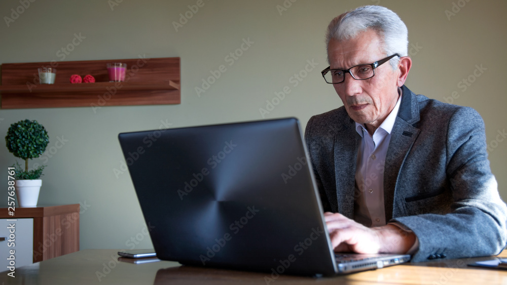 Mature man working from his home Mature man working from his home