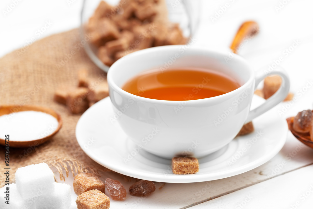 Glass cup of hot tea with sugar on the table Glass cup of hot tea with sugar on the table