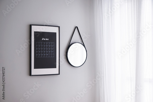 Calendar and mirror on wall...