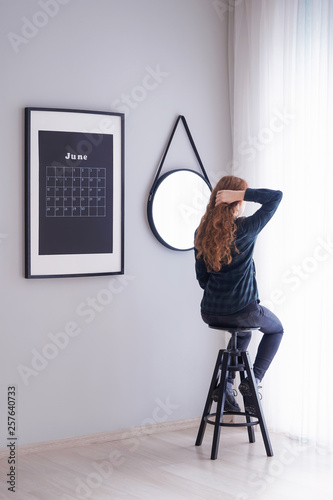 Woman sitting on stool near...