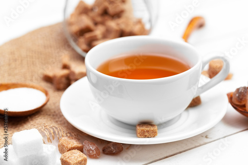 Glass cup of hot tea with sugar on the table © NewFabrika