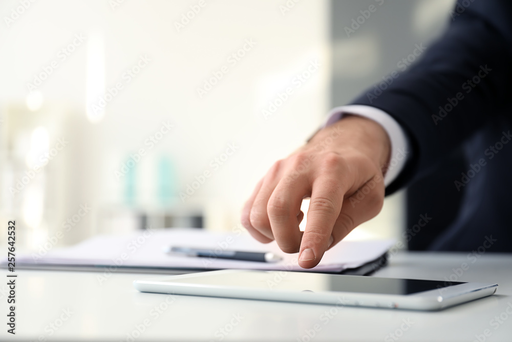 Businessman using tablet computer in office Businessman using tablet computer in office
