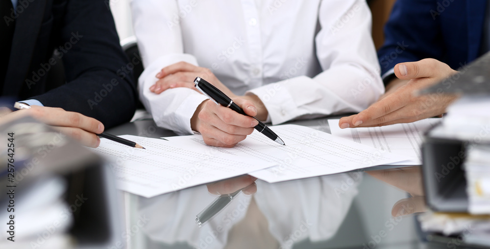 Bookkeepers team or financial inspectors making report, calculating or checking balance. Group of people at work. Business operations concept Bookkeepers team or financial inspectors making report, calculating or checking balance. Group of people at work. Business operations concept