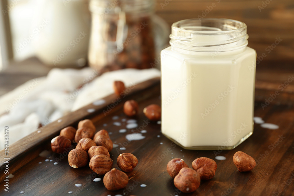 Jar of healthy hazelnut milk on table Jar of healthy hazelnut milk on table