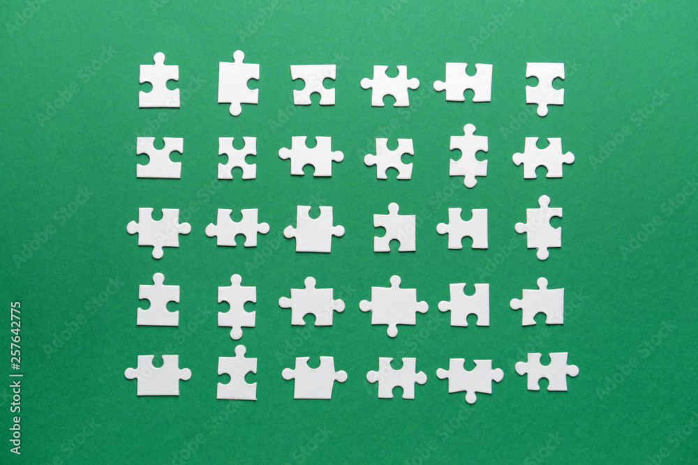 Pieces of puzzle on color background