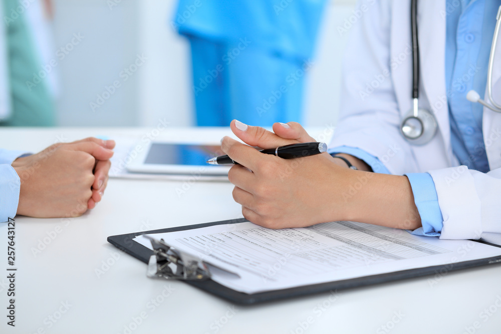 Doctor and patient discussing something, just hands at the table, white background Doctor and patient discussing something, just hands at the table, white background