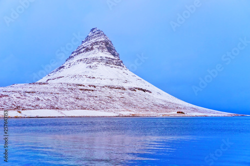 View of the Kirkjufell Mountain at the beachside in Iceland at dawn in winter. photo