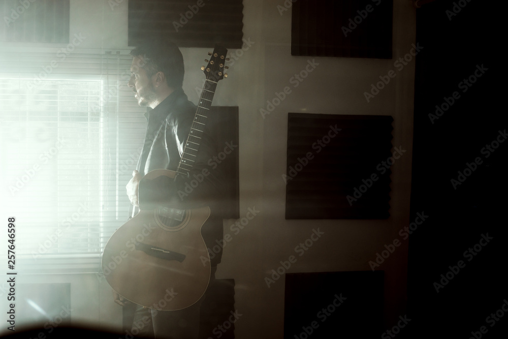 Young man with a classical guitar indoors. Concept Musician guitarist Young man with a classical guitar indoors. Concept Musician guitarist
