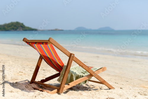 Chaise lounge on the tropical beach at sunny summer day. Travel vacation relax concept.