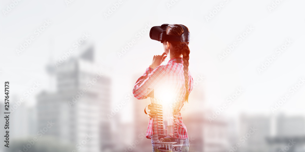 Girl in checked shirt wearing VR glasses experiencing another reality Girl in checked shirt wearing VR glasses experiencing another reality