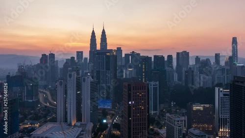4K Cinematic Sunrise Zoom Out Time Lapse Footage of Kuala Lumpur city skyline from the west side of the Malaysian capital.