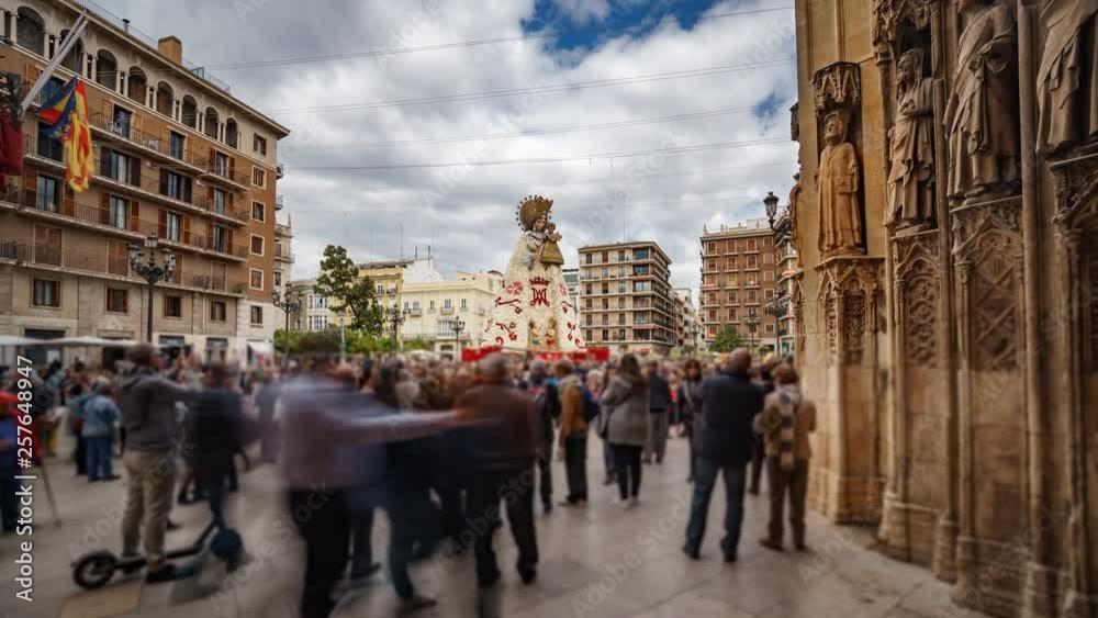Blurred people visit virgin plaza in Valencia from cathedral, time lapse