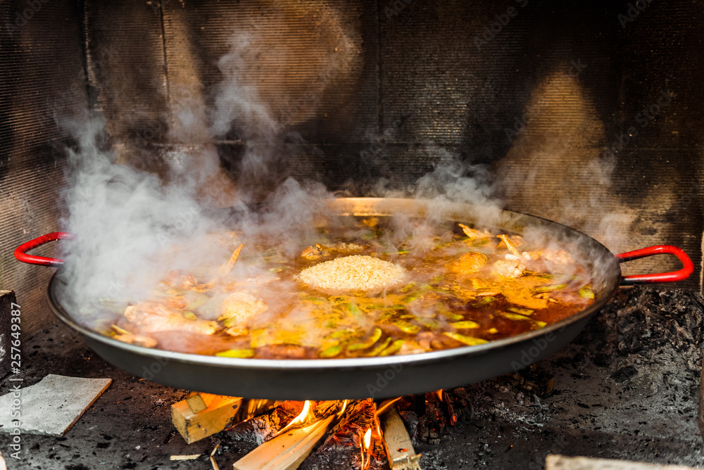 Cooking and making a traditional Spanish Paella over open fire. Cooking and making a traditional Spanish Paella over open fire.