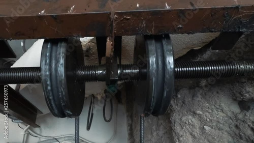 lift machinist repairing elevator in lift shaft. lift mechanism close-up photo