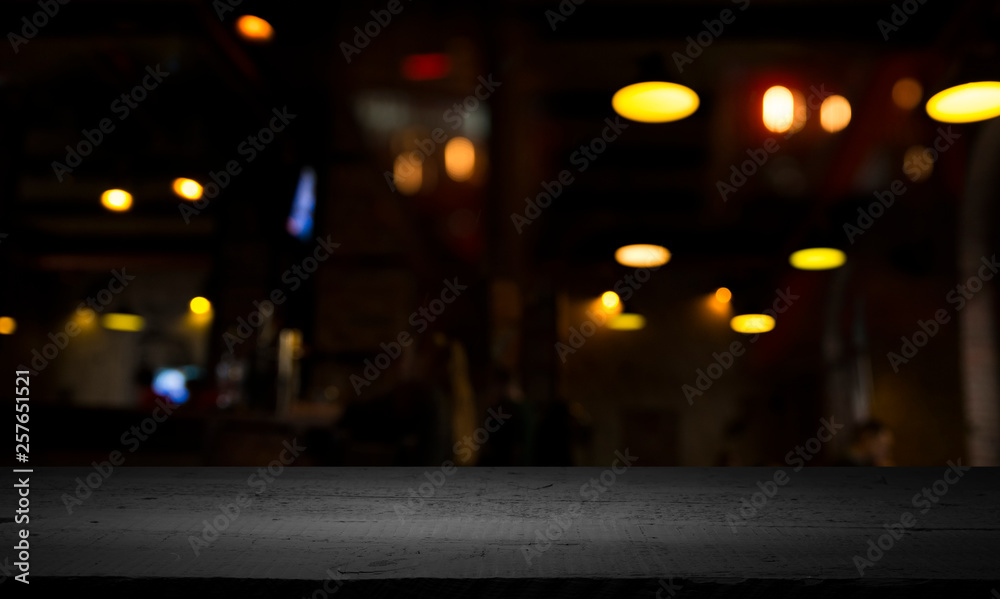 blurred background of bar and dark brown desk space of retro wood