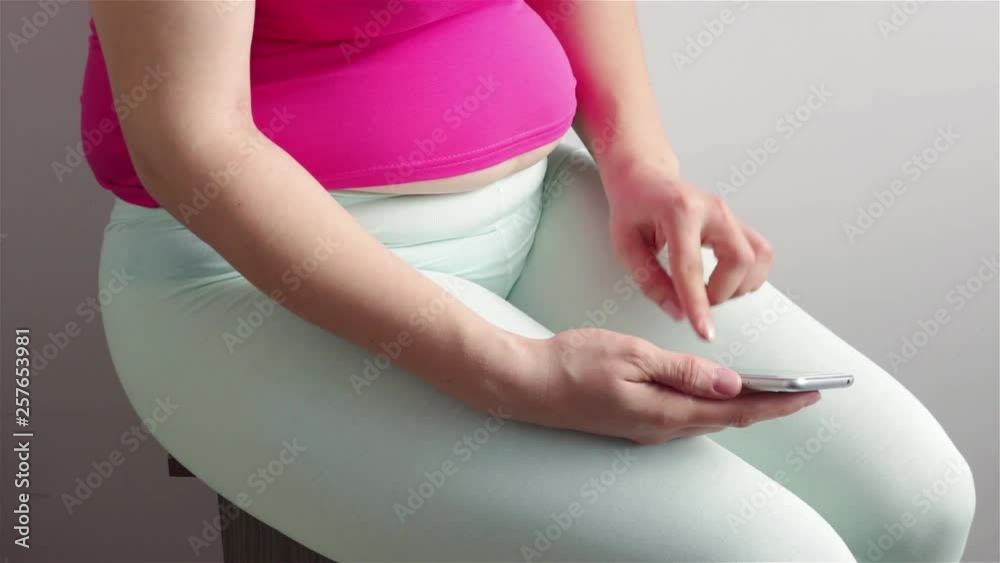 overweight woman using smartphone to control calories close view .weight loss concept