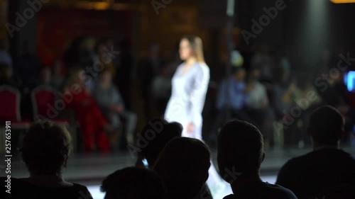 fashion show. fashion podium, female model women girls in stylish dresses of designer walking on runway before audience viewers at defile show. Fashion catwalk event showing new collection of clothes photo