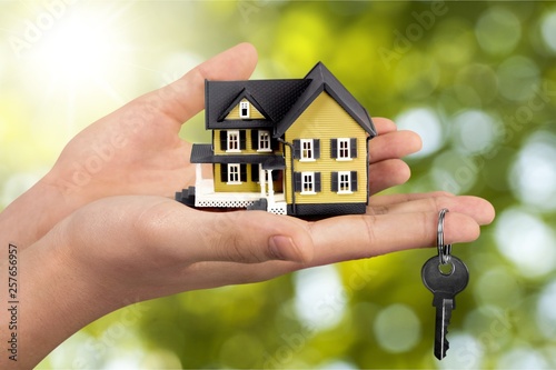 Businessman Holding House Model and Keys, Real Estate Concept