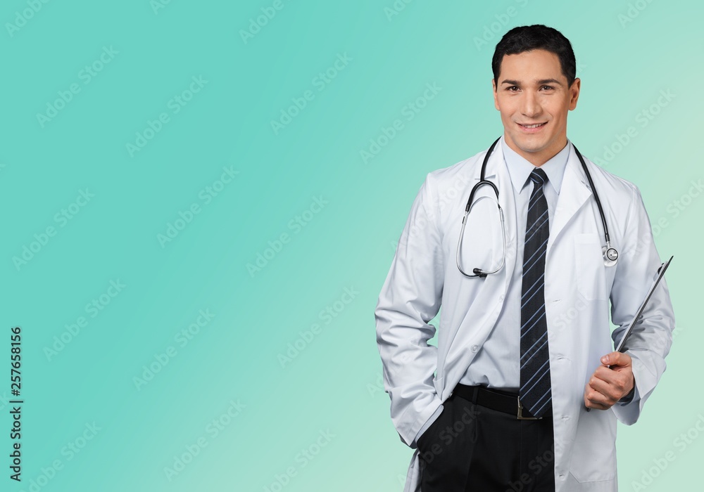 Attractive young female doctor with blurred hospital interior on background