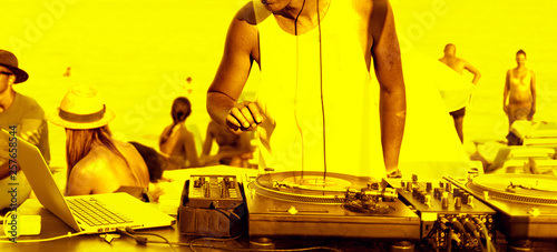 Abstract party flyer - dj's hands and sound equipment. Raving funs around dj's scene