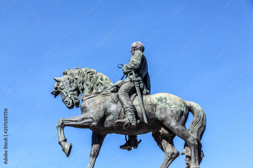 Bronze statue against a blue sky Bronze statue against a blue sky