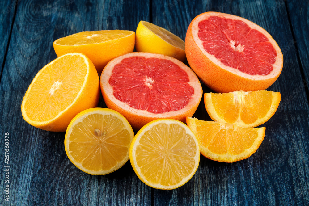 Citrus fruit. Different citrus fruits with leaves of lemon, orange, grapefruit on a blue wooden table. Citrus fruit. Different citrus fruits with leaves of lemon, orange, grapefruit on a blue wooden table.