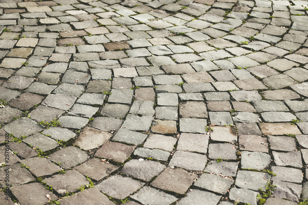 Abstract background. Old cobblestone pavement close-up Abstract background. Old cobblestone pavement close-up