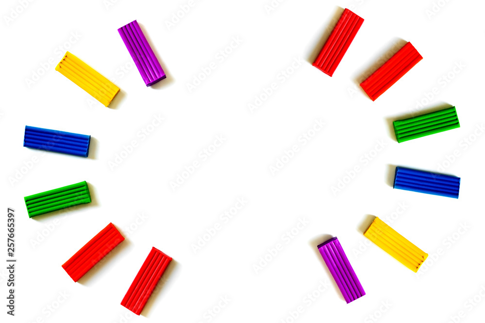 Multi-colored plasticine different shapes on a white background. How to organize classes with children at home. Motor development. Development of children's hands. Concept of education. Multi-colored plasticine different shapes on a white background. How to organize classes with children at home. Motor development. Development of children's hands. Concept of education.