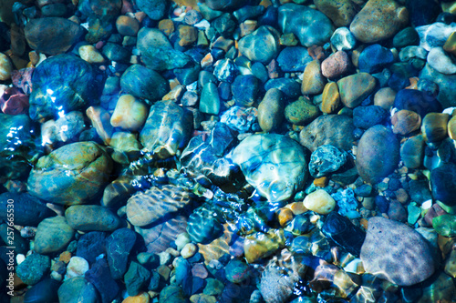 Sea stones in the sea water. Pebbles under water. The view from the top.