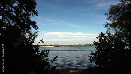 Strong wind blows on a sunny day at the lake
