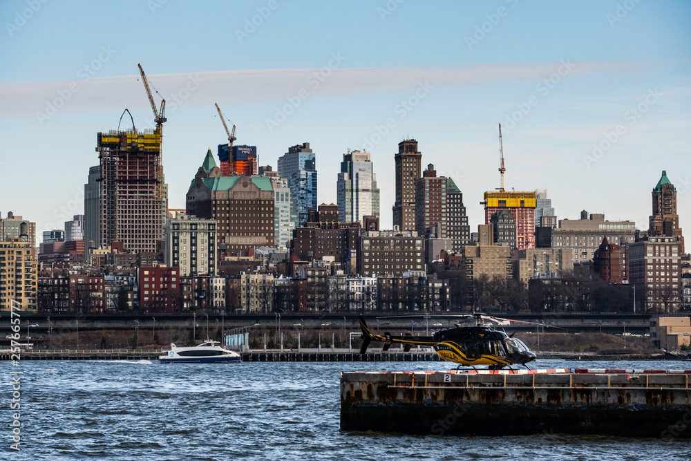 View of a helicopter stop on the pier with background of Brooklyn Heights from east river side in Lower Manhattan New York City
