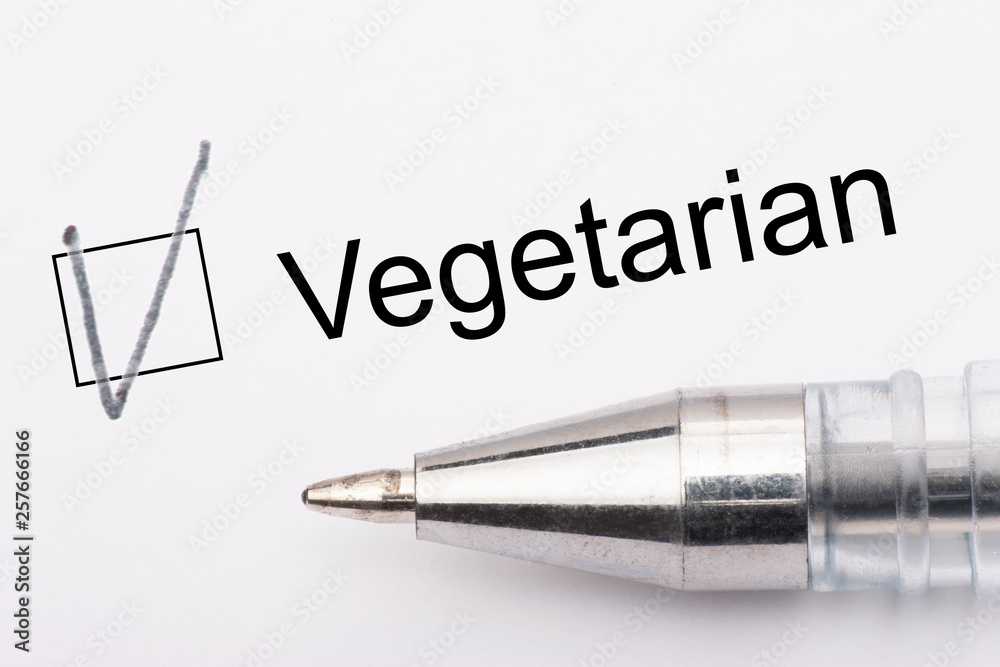 Vegetarian - checkbox with a tick on white paper with metal pen. Checklist concept. Vegetarian - checkbox with a tick on white paper with metal pen. Checklist concept.