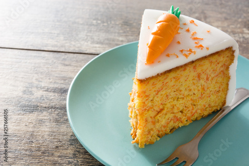 Sweet carrot cake slice on wooden table. photo