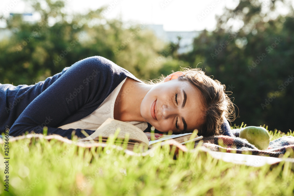 Lovely teenae girl laying on a grass outdoors Lovely teenae girl laying on a grass outdoors