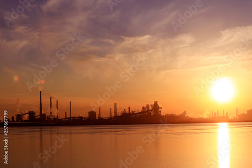 A silhouette of a chemical plant in the setting sun