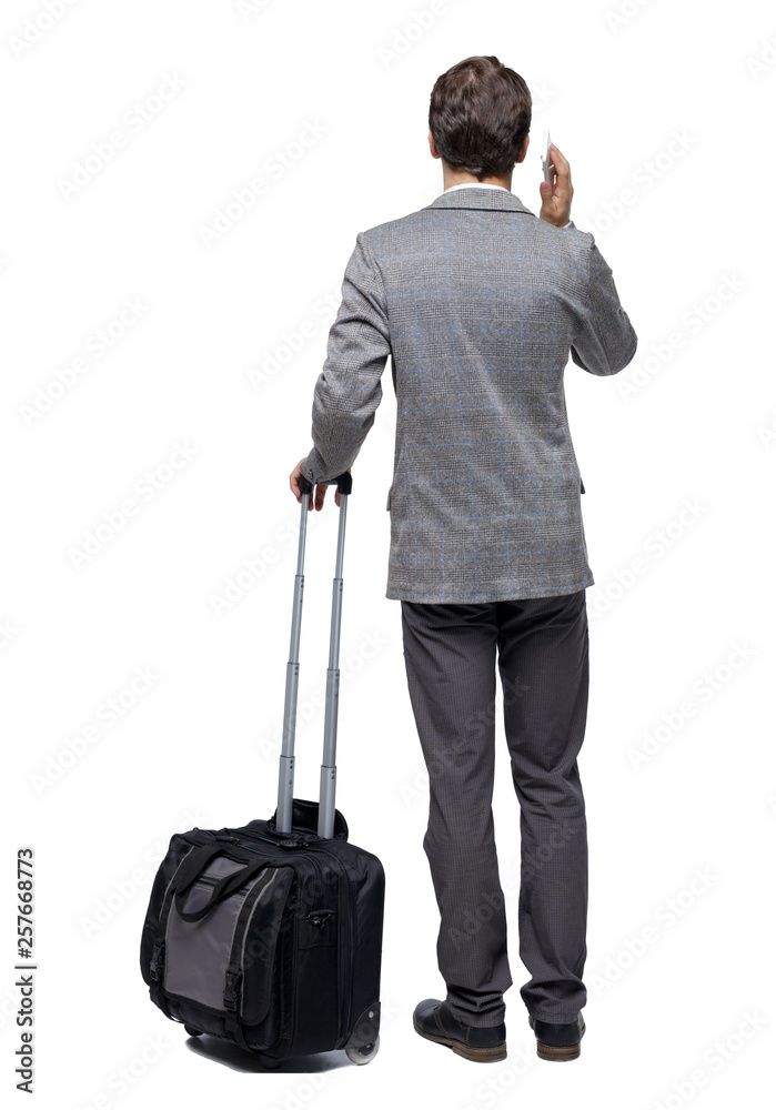 Back view of business man with suitcase talking on the phone. Back view of business man with suitcase talking on the phone.