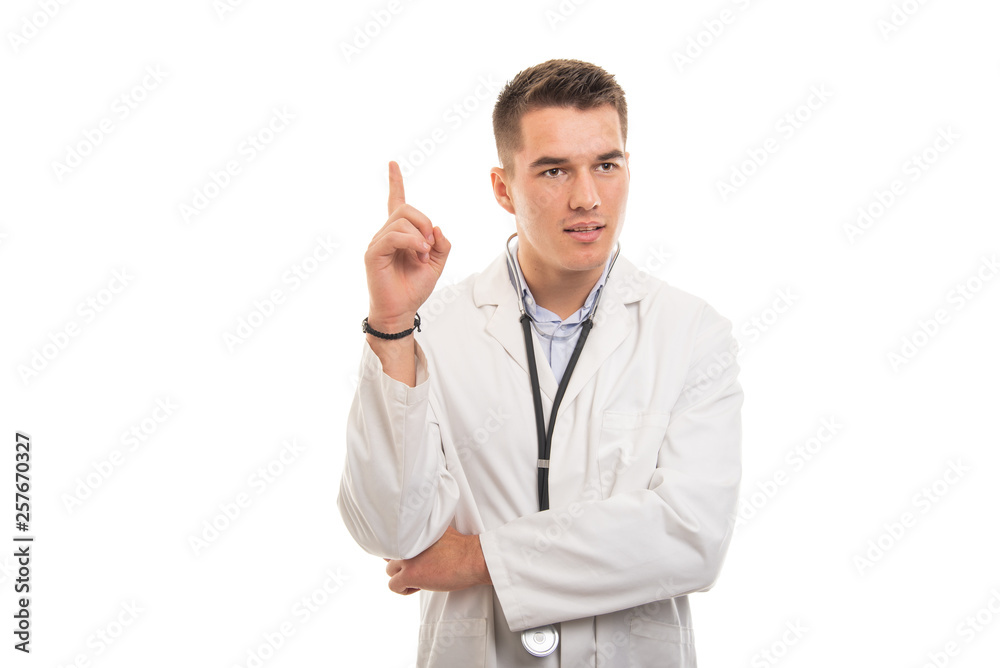 Portrait of young handsome doctor posing like having idea Portrait of young handsome doctor posing like having idea