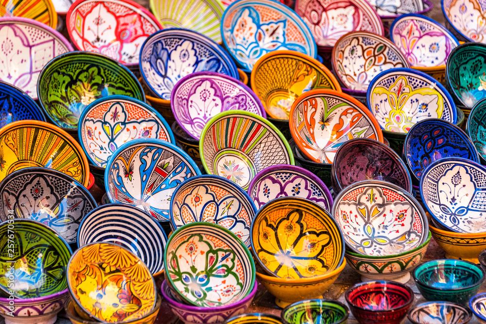 ESSAOUIRA, MOROCCO - NOVEMBER 20, 2018: Moroccan pottery in Essaouira. Colorful ceramics and pottery displayed outside a shop. Beautiful oriental design with plenty of colors.