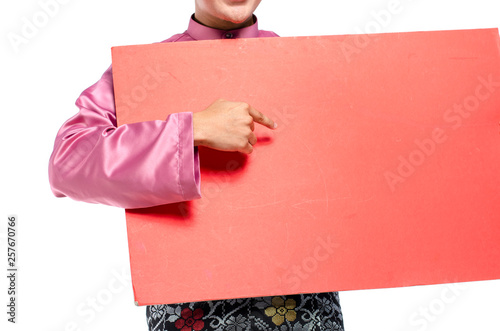 Portrait of young and handsome asian man with traditional clothing holding red cardboard photo